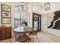 Charming dining area with a round table, decorative lighting, and a view of the front entrance at 11033 E Poinsettia Dr, Scottsdale, AZ 85259