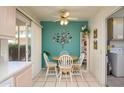 Cozy breakfast nook with a round table, seating for four, and bright, cheerful decor at 12634 W Seneca Dr, Sun City West, AZ 85375