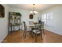 Elegant dining room featuring a glass-top table, seating for four, and stylish decor at 12634 W Seneca Dr, Sun City West, AZ 85375