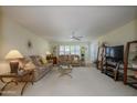 Spacious living room with plush sofas, ceiling fan, and ample natural light at 12634 W Seneca Dr, Sun City West, AZ 85375