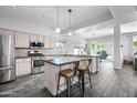 Beautiful kitchen with stainless appliances, center island, granite countertops and pendant lighting at 1345 S Corrine Dr, Gilbert, AZ 85296