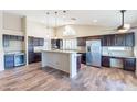 Spacious kitchen featuring modern cabinetry, granite countertops, stainless steel appliances, and a kitchen island at 14443 W Morning Star Trl, Surprise, AZ 85374