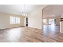 Spacious living room with tile flooring, plantation shutters, and an open floor plan, perfect for entertaining at 14443 W Morning Star Trl, Surprise, AZ 85374