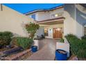 Enclosed front courtyard with pavers, flowering shrubbery, and custom tiled accents create a welcoming private entrance at 15021 N 19Th Way, Phoenix, AZ 85022
