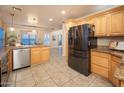 Spacious kitchen featuring stainless steel appliances, wood cabinetry, and an adjoining breakfast nook at 15021 N 19Th Way, Phoenix, AZ 85022