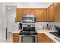 Functional kitchen featuring stainless steel appliances, oak cabinetry, and modern fixtures at 1569 E Princeton Ave, Gilbert, AZ 85234