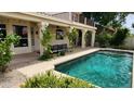 Inviting backyard pool with a covered patio area and lush greenery at 1614 E Kathleen Rd, Phoenix, AZ 85022
