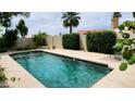 Relaxing backyard pool with neatly trimmed hedges and a refreshing atmosphere at 1614 E Kathleen Rd, Phoenix, AZ 85022