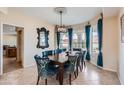 Elegant dining room with stylish chairs, dark wood table, and large windows for natural light at 1614 E Kathleen Rd, Phoenix, AZ 85022