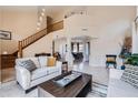 Spacious living room featuring high ceilings, elegant staircase, and comfortable seating arrangement at 1614 E Kathleen Rd, Phoenix, AZ 85022