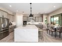 Bright kitchen with stainless steel appliances, large island, and adjacent dining area at 1620 E Cloud Rd, Phoenix, AZ 85086