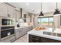 A gourmet kitchen boasts stainless steel appliances, stone countertops, and an island with a sink at 1620 E Cloud Rd, Phoenix, AZ 85086