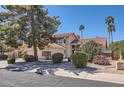 Well-maintained home with mature trees, desert landscaping, and a tile roof, offering a serene and inviting curb appeal at 17246 N 56Th Way, Scottsdale, AZ 85254