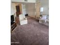 Living room showcasing neutral carpeting and ample space for seating at 17404 N 99Th Ave # 214, Sun City, AZ 85373
