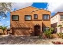 Exterior front view of a stucco home with a 2-car garage, an arched entrance, and desert landscaping at 17604 N 28Th St, Phoenix, AZ 85032