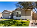 Attractive exterior featuring a low-maintenance landscaped front yard and a neutral stucco facade at 18735 W San Juan Ave, Litchfield Park, AZ 85340
