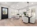 Bright living space with modern furnishings, hardwood floors, and lots of natural light from large windows at 20453 N 95Th Pl, Scottsdale, AZ 85255