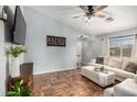 Comfortable living room with tile floors, a ceiling fan, and a plush sofa at 21941 W Solano Dr, Buckeye, AZ 85326