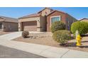 Charming single-story home featuring a two-car garage and low-maintenance desert landscaping with street view at 23740 W Hilton St, Buckeye, AZ 85326