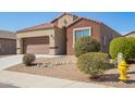 Charming single-story home featuring a two-car garage and low-maintenance desert landscaping with street view at 23740 W Hilton St, Buckeye, AZ 85326