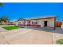 Lovely home with a carport, updated paint, and a tidy front yard ready for new owners at 3029 W Windrose Dr, Phoenix, AZ 85029