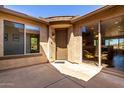 Inviting front entrance featuring a decorative door, a paved patio, and abundant natural light at 31525 N Gold Field Rd, San Tan Valley, AZ 85143