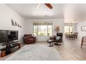 Comfortable living room with tile floors, lots of seating, and a bright window with desert views at 31525 N Gold Field Rd, San Tan Valley, AZ 85143