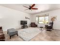 Spacious living room with tile floors, a ceiling fan, and a bright window with desert views at 31525 N Gold Field Rd, San Tan Valley, AZ 85143