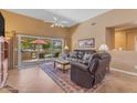 Cozy living room with a ceiling fan, tile floors, and access to the patio at 4638 S San Benito Ct, Gilbert, AZ 85297