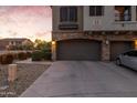 Spacious two-car garage with a private driveway and well-kept landscaping near a cluster of units at 470 N 168Th Ln, Goodyear, AZ 85338