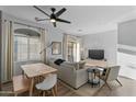 Bright living room with a ceiling fan, modern furniture, and plenty of natural light at 470 N 168Th Ln, Goodyear, AZ 85338