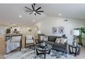 Comfortable living room with stylish decor, ceiling fan, and access to kitchen at 4846 E Grandview St, Mesa, AZ 85205