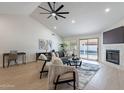 Bright living area with fireplace, ceiling fan, access to patio, and modern furnishings at 4846 E Grandview St, Mesa, AZ 85205