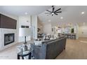 Open living room showcases fireplace, vaulted ceiling, ceiling fan, and wood floors at 4846 E Grandview St, Mesa, AZ 85205