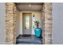 Close-up of the stone-accented front entrance with a decorative glass front door at 5100 S Peach Willow Ln, Gilbert, AZ 85298