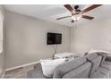 Cozy living room features a modern ceiling fan and a comfortable gray sofa at 520 N Stapley Dr # 286, Mesa, AZ 85203