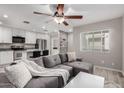 Open concept living space with kitchen view, and stylish gray sectional couch at 520 N Stapley Dr # 286, Mesa, AZ 85203
