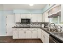 Bright kitchen with white cabinets, granite countertops, and stainless steel appliances at 5865 E Anaheim St, Mesa, AZ 85205