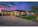 Home featuring a three car garage and large driveway with brick pavers at 6328 W Fetlock Trl, Phoenix, AZ 85083