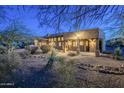 Beautiful backyard with desert landscaping and covered patio at 6545 E Ponderosa Loop, Gold Canyon, AZ 85118