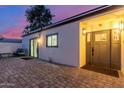 Cozy backyard entrance with a brick patio, comfortable seating, and a welcoming door at 8618 E Via De Encanto --, Scottsdale, AZ 85258