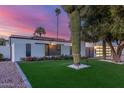 Contemporary home boasts a beautifully landscaped front yard with mature trees and cacti at 8618 E Via De Encanto --, Scottsdale, AZ 85258