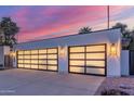 A home with modern garage doors featuring black trim and unique lighting at 8618 E Via De Encanto --, Scottsdale, AZ 85258