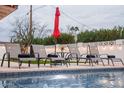 Relaxing pool area with comfortable lounge chairs and an umbrella, ideal for enjoying sunny days at 8725 E Vista Dr, Scottsdale, AZ 85250