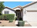 Inviting front entrance with desert landscaping, security door, and well maintained facade at 9512 E Kilarea Ave, Mesa, AZ 85209