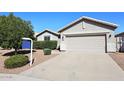 Exterior of a well-kept, single-story house with a two-car garage, complemented by a manicured front yard at 9512 E Kilarea Ave, Mesa, AZ 85209