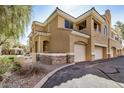Two-story home featuring stucco siding, two car garages, and stone veneer accents for a luxurious aesthetic at 955 E Knox Rd # 224, Chandler, AZ 85225