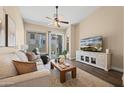 Cozy living room featuring a ceiling fan, sliding glass doors, and comfortable seating at 1024 E Frye Rd # 1093, Phoenix, AZ 85048