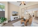 Bright living room with updated flooring, a decorative rug, and a view into dining area at 1024 E Frye Rd # 1093, Phoenix, AZ 85048