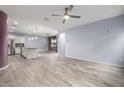 Spacious living area with neutral walls, tile floors, and ceiling fan creating a versatile open space at 10320 E Tupelo Ave, Mesa, AZ 85212